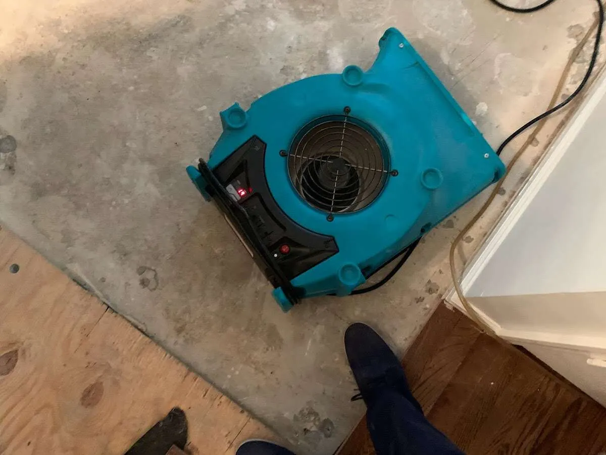 Air mover drying subfloor during Leak Detection & Repair in North Greenbush